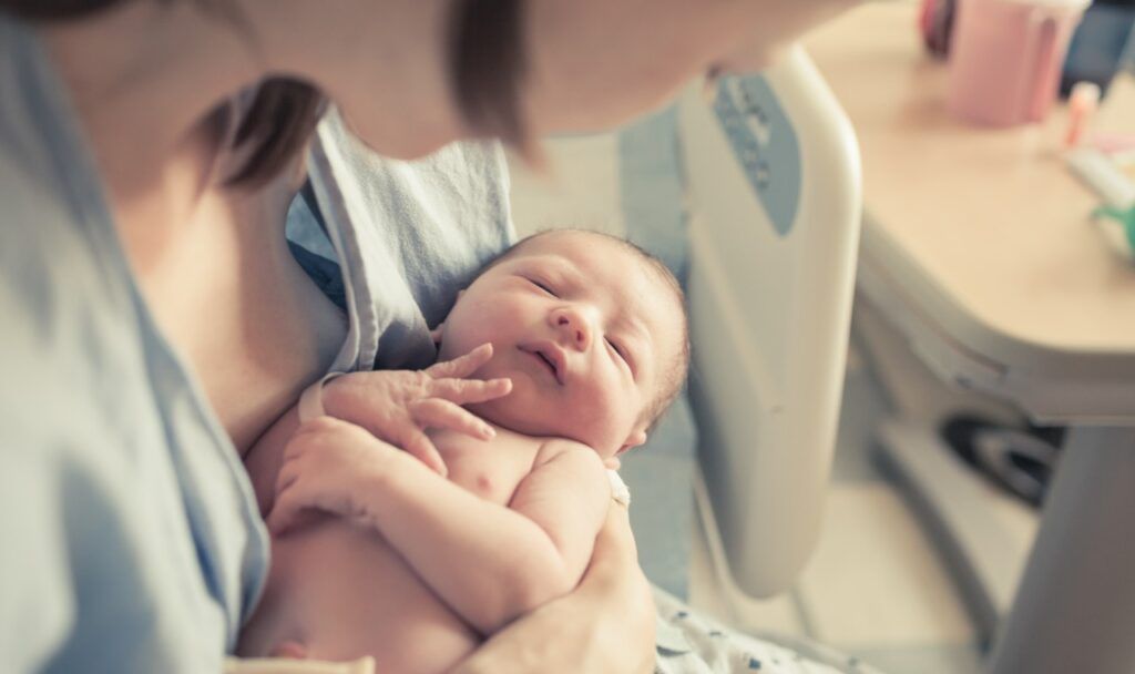 Baby and mother in hospital.